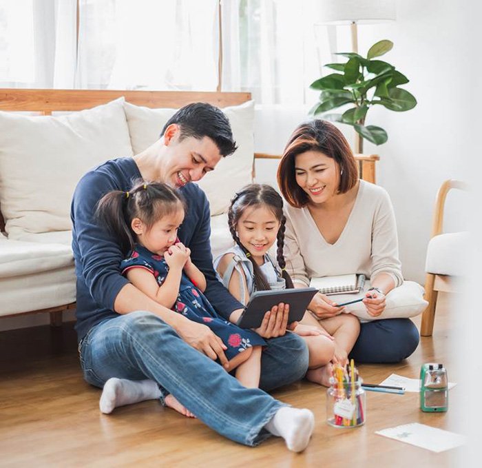 parents and their children sitting on the floor