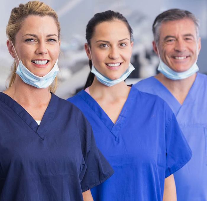 a dentist and their team smling