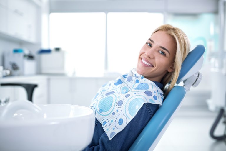 Woman at dentist using her dental insurance